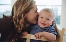 Mother kissing baby