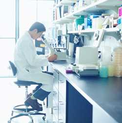 Man looking through microscope