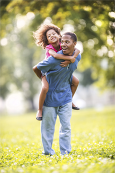 a man carrying a child on his back