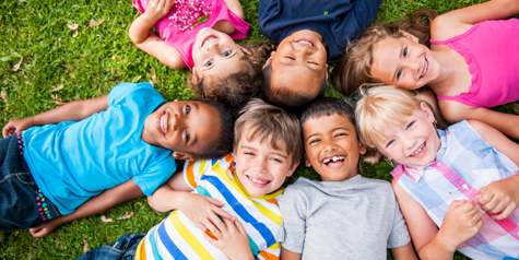 Children on the ground smiling