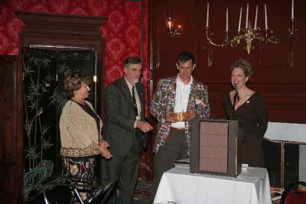 Door prizes:  The evening ended with a splash by handing out door prizes; among those prizes: a day at the spa, books, chocolates, and many, many more! Pictured from left to right:  Dwan Hightower (assisted with donation of prizes),  Fred Martich (Membership Chair), Ted Pestorius (President-Elect) and Stacy Harper (President). 