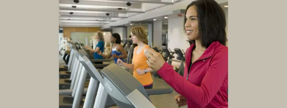 Women in a gym using exercise equipment