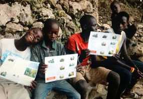 Local boys learning about rabies and how to stay safe from rabid dogs from materials brought by Tran and her team.